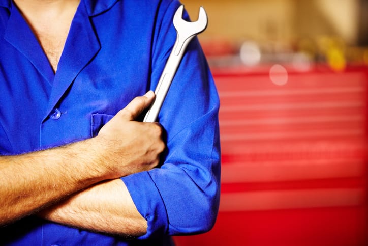 Carolina Collision and Frame Service | Auto mechanic holding a wrench with his arms crossed