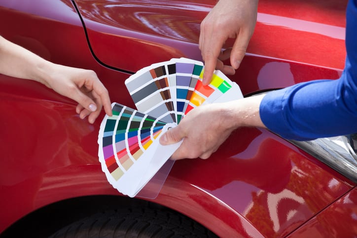Carolina Collision and Frame Service | Auto paint technician going over various paint colors with a customer using a swatch book