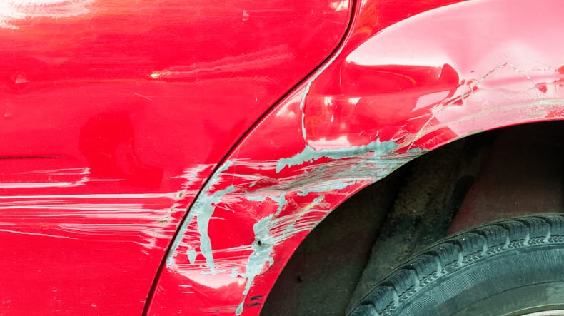 Carolina Collision and Frame Service | Dents and scratches on the side panel of a red truck