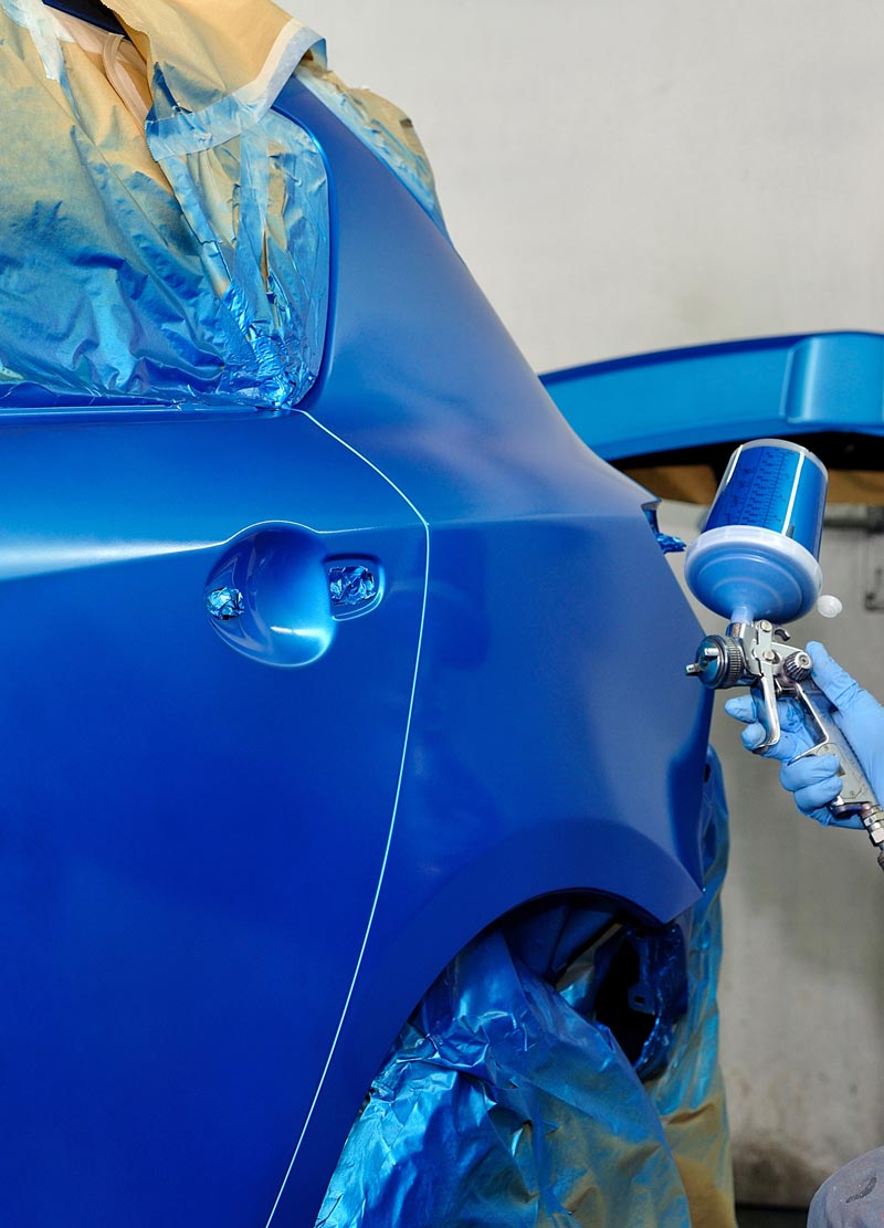 Carolina Collision and Frame Service | Paint technician at auto body shop painting a car